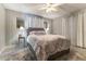Spacious bedroom with ceiling fan, plush bedding, and plenty of natural light at 12359 Ne Highway 314, Silver Springs, FL 34488