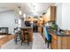 Modern kitchen with wood cabinets, granite countertops and black appliances at 12359 Ne Highway 314, Silver Springs, FL 34488