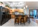 Modern kitchen with wood cabinets, granite countertops and black appliances at 12359 Ne Highway 314, Silver Springs, FL 34488