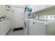 Laundry room with washer, dryer and extra storage at 12359 Ne Highway 314, Silver Springs, FL 34488