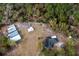 Aerial view of home with detached structures and solar panels at 12359 Ne Highway 314, Silver Springs, FL 34488