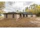 Brick house with a green roof and arched windows at 12359 Ne Highway 314, Silver Springs, FL 34488