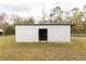 Galvanized metal storage building with open door, workbench inside at 12359 Ne Highway 314, Silver Springs, FL 34488