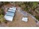 Aerial view of property with multiple outbuildings and solar panels at 12359 Ne Highway 314, Silver Springs, FL 34488