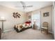 Cozy bedroom with floral bedding and ceiling fan at 5 Hemlock Terrace Pass, Ocala, FL 34472