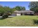Single-story house with beige exterior, garage, and landscaped yard at 5 Hemlock Terrace Pass, Ocala, FL 34472