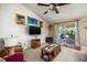 Living room features a large TV, sliding glass doors to patio, and carpeted floors at 5 Hemlock Terrace Pass, Ocala, FL 34472