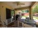 Covered patio with seating area, ceiling fan, and backyard access at 5 Hemlock Terrace Pass, Ocala, FL 34472