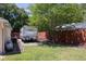 Spacious backyard with a camper, shed, and large trees at 5 Hemlock Terrace Pass, Ocala, FL 34472