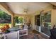 Covered patio with seating area, ceiling fan, and backyard access at 5 Hemlock Terrace Pass, Ocala, FL 34472