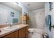 Clean bathroom with tub shower, vanity, and wood cabinets at 5 Hemlock Terrace Pass, Ocala, FL 34472