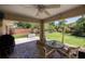 Brick patio with seating area, ceiling fan, and backyard access at 5 Hemlock Terrace Pass, Ocala, FL 34472