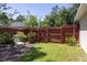 Landscaped backyard with wooden fence and gate at 5 Hemlock Terrace Pass, Ocala, FL 34472