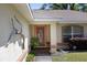 Front entry with orange door, unique decor, and walkway at 5 Hemlock Terrace Pass, Ocala, FL 34472
