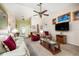 Bright living room featuring comfortable seating and a large TV at 5 Hemlock Terrace Pass, Ocala, FL 34472