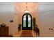 Elegant entryway with arched double doors and chandelier at 14950 Nw 216Th Pl, Micanopy, FL 32667