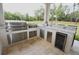 Outdoor kitchen with stainless steel appliances and granite countertops at 14950 Nw 216Th Pl, Micanopy, FL 32667