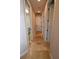 Hallway with tile flooring and access to laundry room at 14950 Nw 216Th Pl, Micanopy, FL 32667