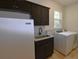 Laundry room with washer, dryer, sink, and cabinets at 14950 Nw 216Th Pl, Micanopy, FL 32667