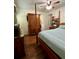 Bedroom with wood floors, a large wardrobe, and a queen bed at 14468 Ne 204Th Ln, Fort Mc Coy, FL 32134
