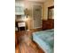 Bedroom with wood floors, a dresser, and a queen bed at 14468 Ne 204Th Ln, Fort Mc Coy, FL 32134