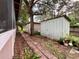 Backyard with a shed, brick pathway and landscaping at 14468 Ne 204Th Ln, Fort Mc Coy, FL 32134