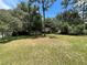 Large grassy backyard with mature trees and shed at 14468 Ne 204Th Ln, Fort Mc Coy, FL 32134