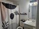 Clean and modern bathroom with a stylish shower curtain and updated fixtures at 11718 Sir Winston Way, Orlando, FL 32824