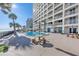 Relaxing pool area with tables, chairs, and beach views at 89 S Atlantic Ave # 204, Ormond Beach, FL 32176