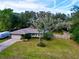 House exterior view showcasing a ranch style home and yard at 19831 Sw Nightingale Dr, Dunnellon, FL 34431