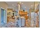 Open kitchen with light wood cabinets, tile flooring, and island with seating at 3290 Se 53Rd Ct, Ocala, FL 34480