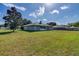 Back exterior view of house featuring a large yard at 3290 Se 53Rd Ct, Ocala, FL 34480