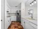 Modern kitchen featuring white cabinetry, stainless steel refrigerator, and tile flooring at 3601 Se 24Th Ave, Ocala, FL 34471