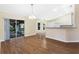 Bright dining area with laminate floors and view to screened patio at 9573 Sw 53Rd Cir, Ocala, FL 34476