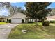Single-story home with attached garage and landscaped lawn at 9573 Sw 53Rd Cir, Ocala, FL 34476