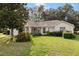 Single-story home with a neatly landscaped yard and attached garage at 9573 Sw 53Rd Cir, Ocala, FL 34476