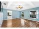Main bedroom with hardwood floors and ensuite bathroom access at 9573 Sw 53Rd Cir, Ocala, FL 34476