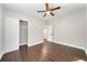 Bedroom with wood-look flooring, ceiling fan, and ample closet space at 3777 Martin St, Orlando, FL 32806