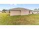 Exterior view of the back of the house with a grassy lawn at 7186 Sw 113Th Loop, Ocala, FL 34476