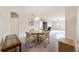 Dining area with round table, chairs, and view of the living room at 7186 Sw 113Th Loop, Ocala, FL 34476