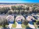 Aerial view of three homes with driveways and landscaping in a residential community at 16465 Sw 14Th Ave, Ocala, FL 34473