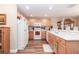 Kitchen with light wood cabinets, white appliances, and ample counter space at 16465 Sw 14Th Ave, Ocala, FL 34473