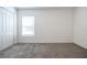 Bright bedroom featuring grey carpet, window with blinds and double door closet at 2327 Sw 168Th Loop, Ocala, FL 34473