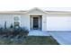 Front entrance of a newly built home, showcasing a dark-brown door and landscaping at 2327 Sw 168Th Loop, Ocala, FL 34473