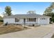 White single-story house with attached garage and landscaped yard at 6482 Sw 81St St, Ocala, FL 34476