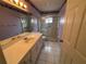 Bathroom with shower, vanity, and tiled floor at 9981 Sw 59Th Cir, Ocala, FL 34476