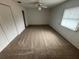 Well-lit bedroom with neutral carpeting and double closets at 9981 Sw 59Th Cir, Ocala, FL 34476