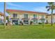 Two-story building with balconies, red tile roofs and a lush lawn at 14 Ocean Palm Villa S # 14, Flagler Beach, FL 32136