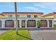 Condo exterior featuring a Spanish-style roof and attached garages at 14 Ocean Palm Villa S # 14, Flagler Beach, FL 32136