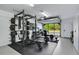 Well-equipped home gym with a power rack, weight bench, and various other exercise equipment at 14 Ocean Palm Villa S # 14, Flagler Beach, FL 32136